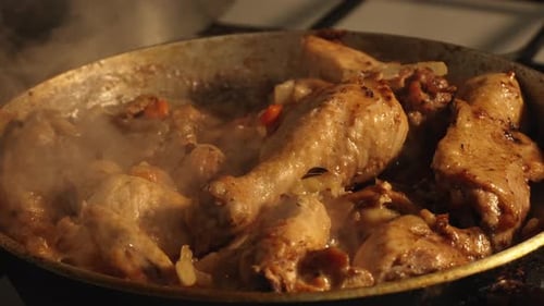 Close-up of Chicken Simmering in a Frying Pan