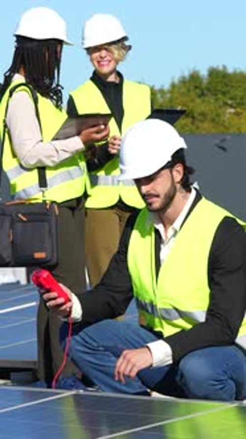Engineers Inspect Solar Panels with Meter