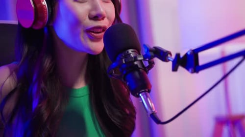 Woman Talking into Microphone on Boom with Headphones