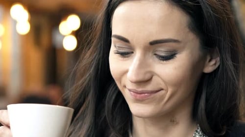 Young, Elegant Woman Relaxing And Drinking Coffee In Cafe