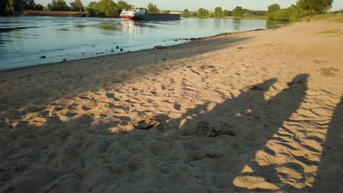 A big container shipping ship is passing by at the river in the Netherlands