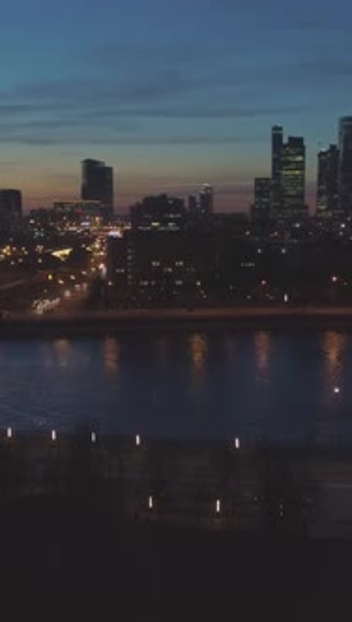 Illuminated Moscow City Business Center and Cityscape at Evening Twilight Aerial View Vertical Video