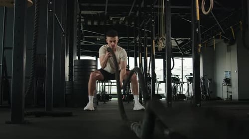 Man Working out with Ropes in a Gym