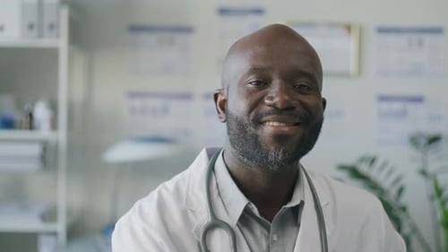 Portrait of Smiling Black Doctor Working in Medical Office