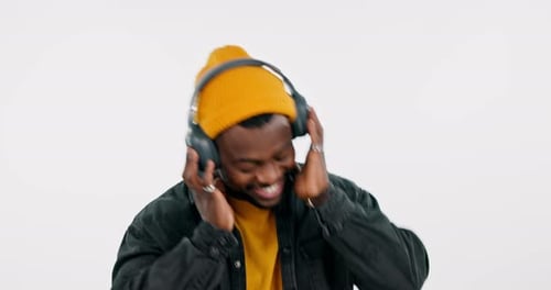 Studio, dancing or happy black man listening to music for freedom in headphones on white background