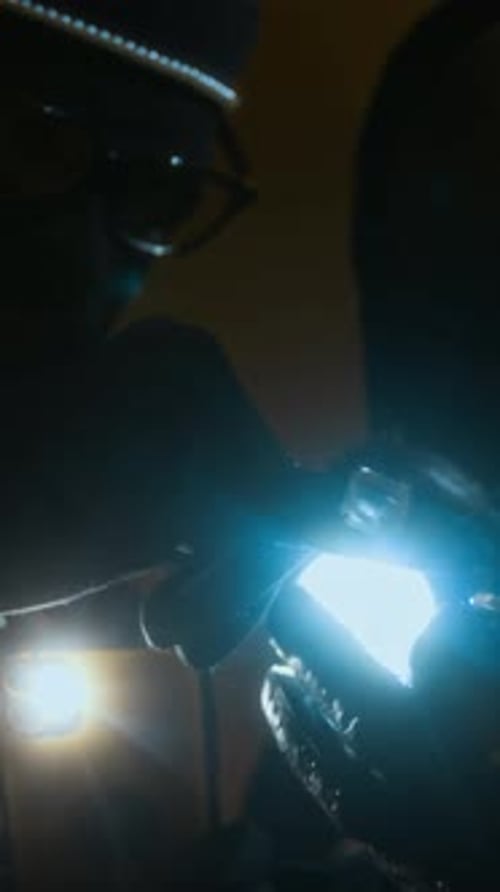 Dimly Lit People Using Flashlights