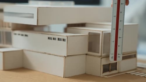 Skilled professional engineer hand using ruler measure house model. Immaculate.