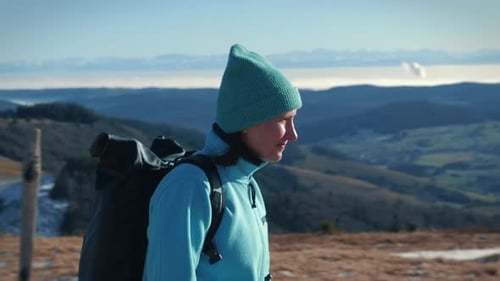 Female tourist hiking along mountain range, enjoying amazing mountain nature