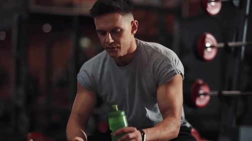 Portrait Young Man Use Phone Drink Water in Gym Sportsman Sport Fitness Internet Face Technology Fit