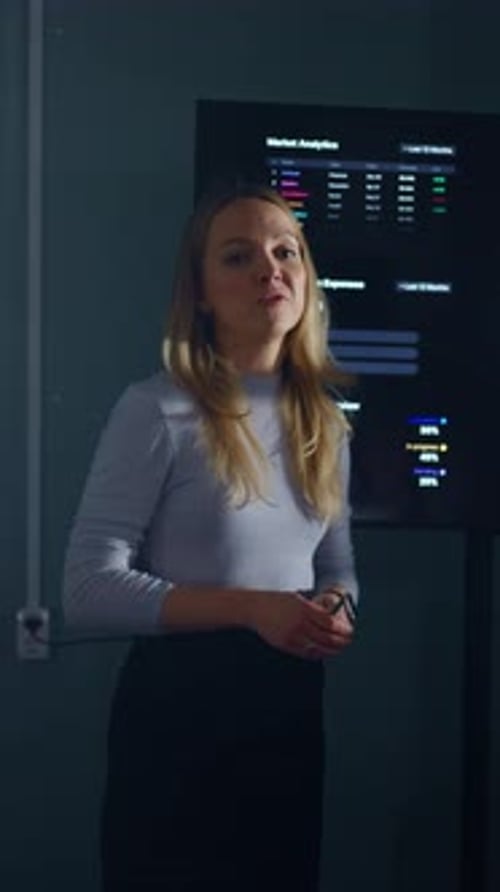 Woman Presenting Financial Data in a Corporate Office