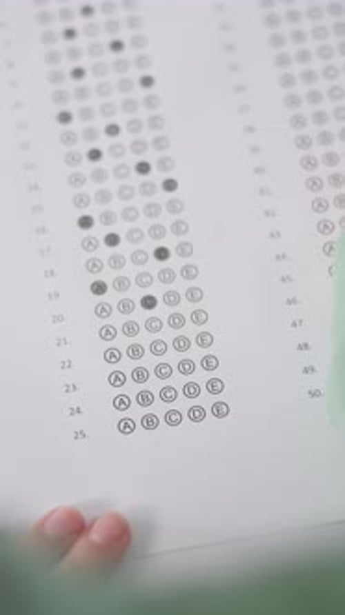 Hands, writing and student with multiple choice test in classroom at school for scholarship