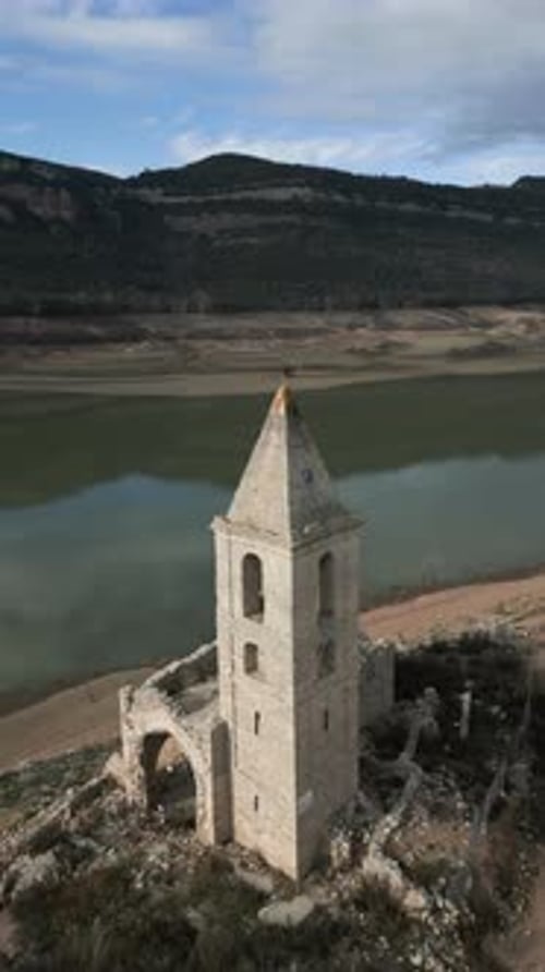 Vertical Drone Shot of Church Sau Swamp Dike in Catalonia Spain Drought in 2024 Pantano De Sau