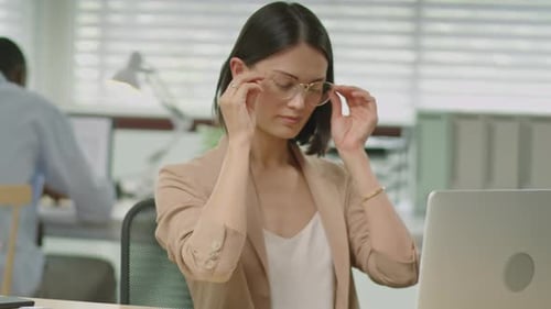Tired Businesswoman Having Stressful Day in Office