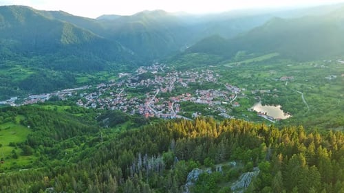View From Rock to Town of Smolyan with Meadows for Cattle Walking and Houses Between Mountain Range