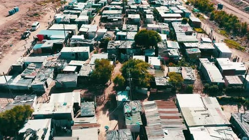 Poor, community and houses in a neighborhood from drone with village, street