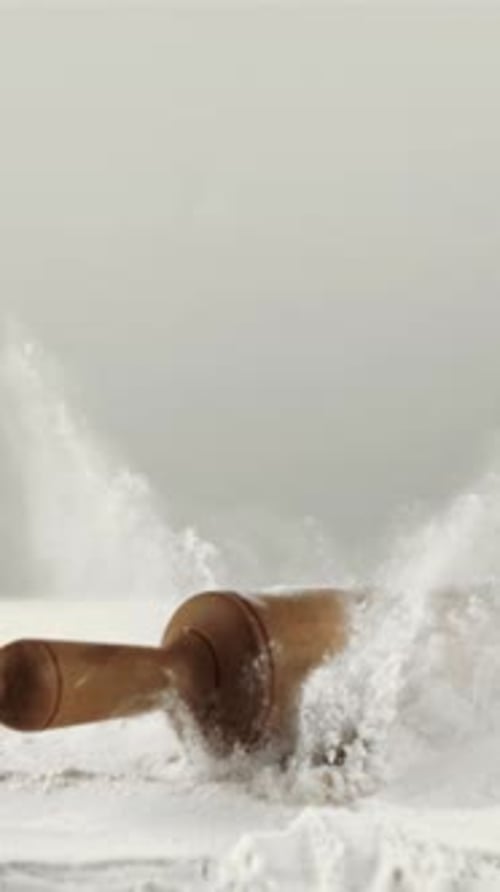 Super Slow Motion in the Flour Falls a Wooden Rolling Pin Filmed on a Highspeed Camera at 1000 Fps