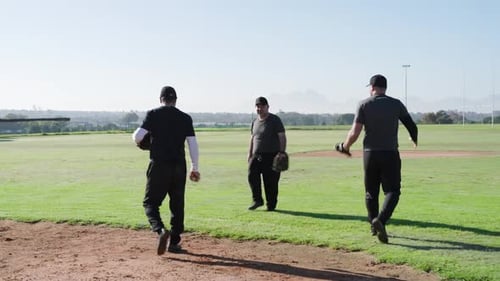 After glove checks and baseball tosses, male teammates practicing catch drill on infield edge