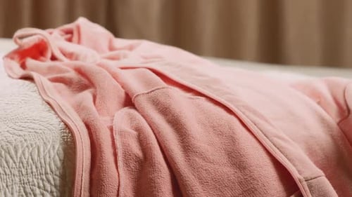 Clothes Being Stacked on Bed in Bedroom Close Up