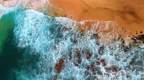 Fantastic foamy waves splash on the sandy shore. Pacific Ocean arrive to the beach.