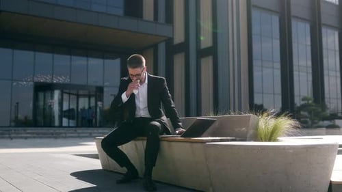 Young Adult Eating Lunch and Working Outdoors