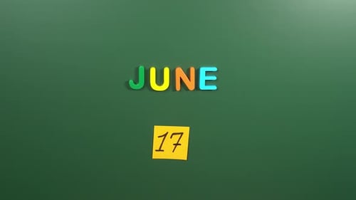 Hand sticking a sticker 17 June calendar day on school board. 17 date of June. Seventeenth day
