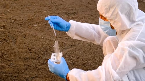 Scientist Collects Soil Samples in Rural Field