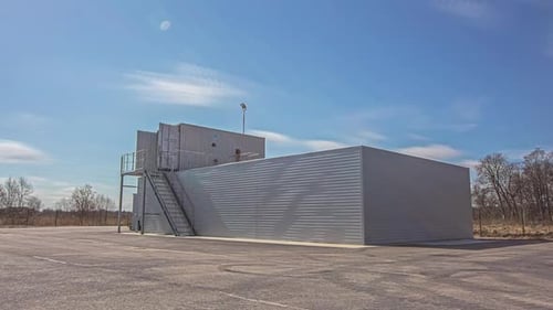 Shot of sewage water treatment plant with sediment tank for water purification at daytime with cloud