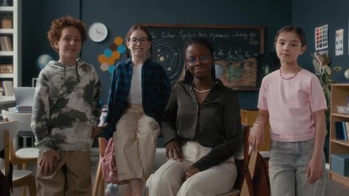 Teacher and Students Smiling in Classroom Portrait