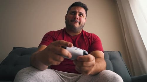 Young Adult Gaming on a Couch Indoors