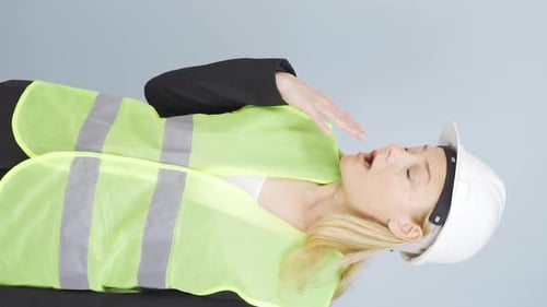 Vertical video of Engineer looking at camera in amazement and making a presentation.