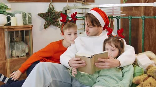 Father Reads Christmas Story to Children at Home