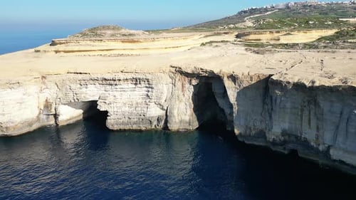 Aerial drone view of cliffs in Malta and the Mediterranean Sea
