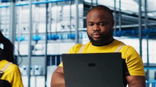 Smart Factory Engineer Implements Automated Workflows Using Laptop