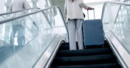 Airport, luggage and the back of a business employee on an escalator for international travel