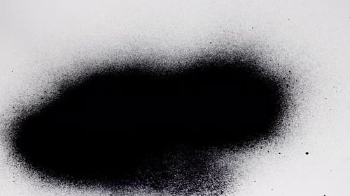 Black Paint Spray Spreading on White Background