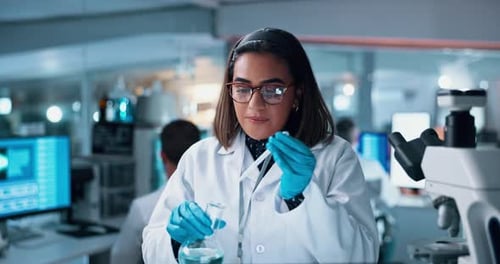 Scientist, woman and chemical with microscope testing for chemistry, smile and medical research