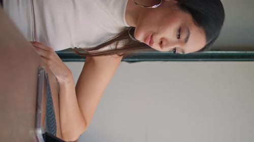 Beautiful Student Studying Online Using Laptop in Cafeteria Close Up Vertical