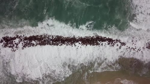 Powerful Ocean Waves Crashing on a Rock Barrier