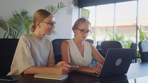 Collaborative Young Adults Working Together at Table