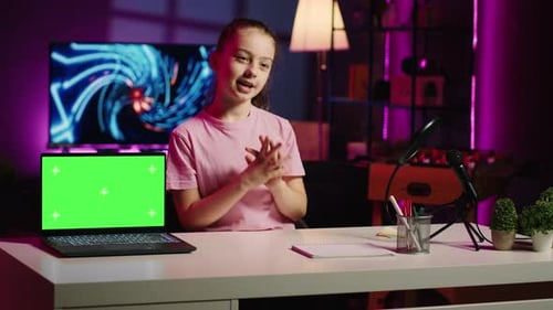Cute Kid in Home Studio Presenting Advertisement From Sponsoring Brand on Green Screen Laptop