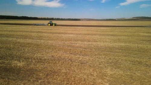Tractors plowing the field in Ukraine