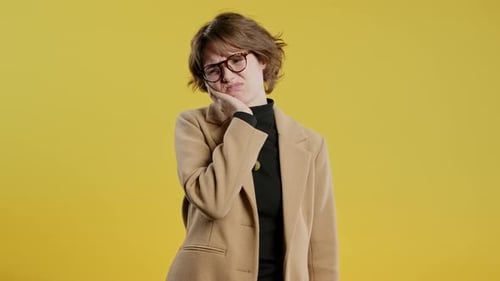 Young Businesswoman with Tooth Pain Yellow backgroundToothache Dental Problem