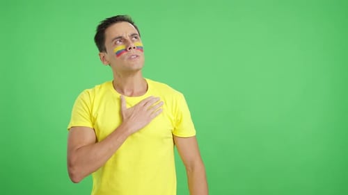 Man Listening to the Colombia National Anthem with Solemnity