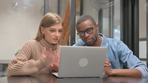 Adults Having a Virtual Meeting at Work