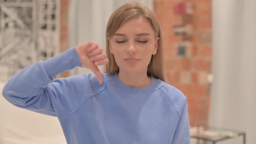 Portrait of Young Woman Doing Thumbs Down