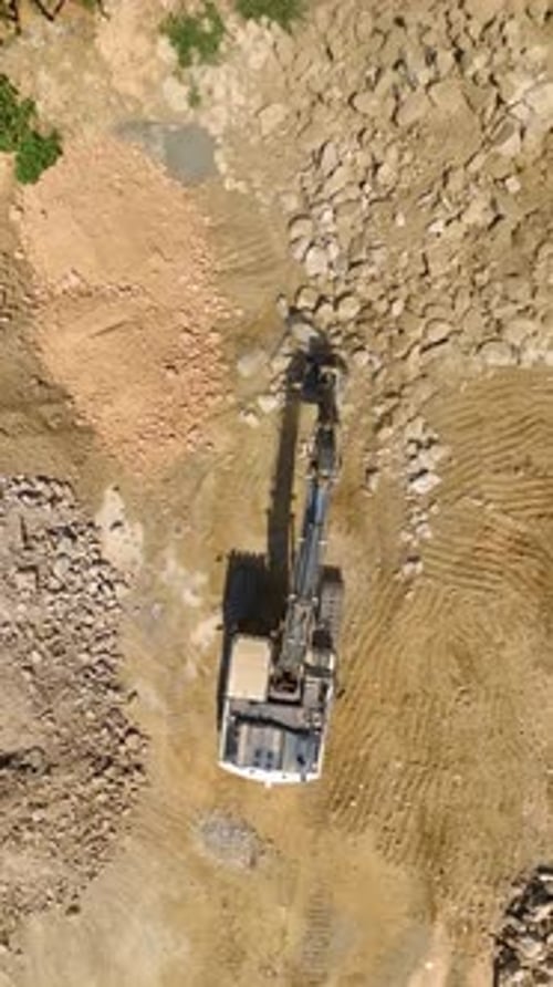 Vertical Video Aerial Progress Perspective on Tractor Preparing Land for Residential Complex