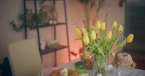 Festive Easter Table with Cake and Yellow Tulips