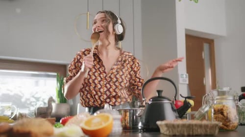 Woman Singing and Dancing in Her Kitchen
