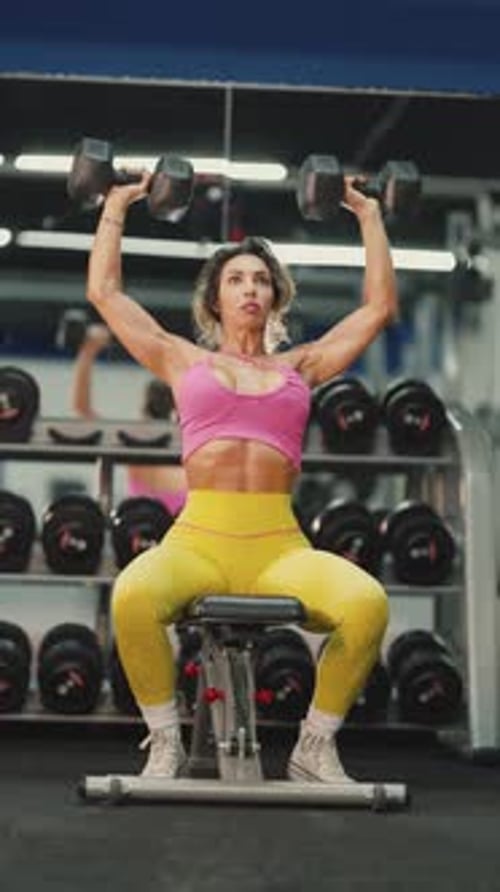 Gym Determined Athletic Woman Lifting Dumbbells During Shoulder Press Workout