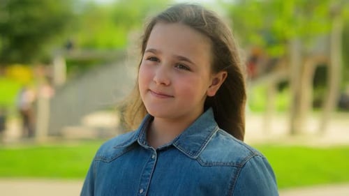 Smiling Girl in Denim Shirt in Park